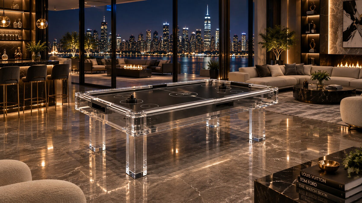 A glass air hockey table in an evening room overlooking a blue city skyline
