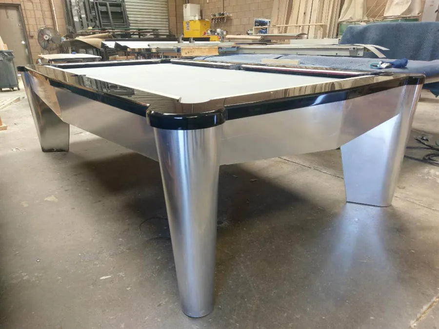 A finished custom pool table with metal legs in the CB Design workshop