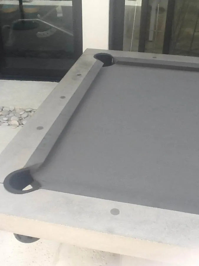 Close-up of a grey rail and drop pocket on a custom pool table