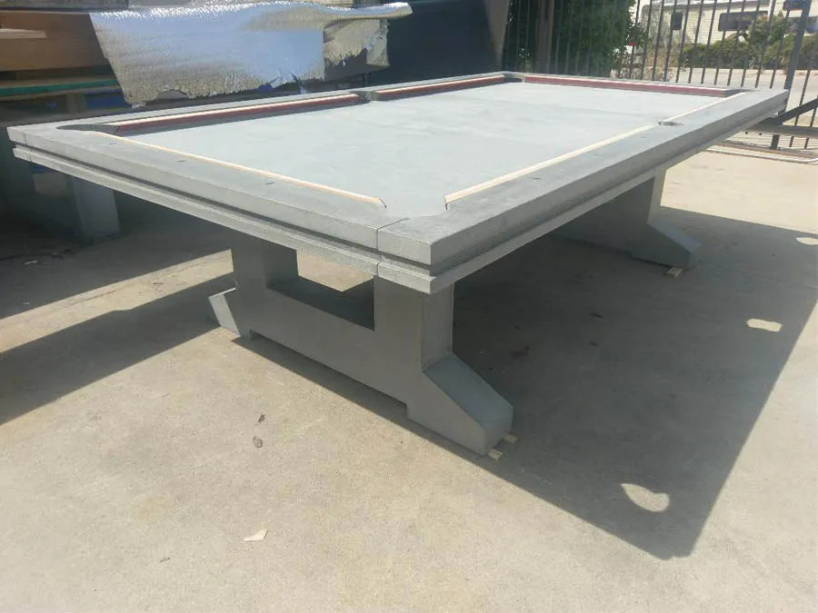 A custom pool table with a grey cantilever pedestal base in the workshop