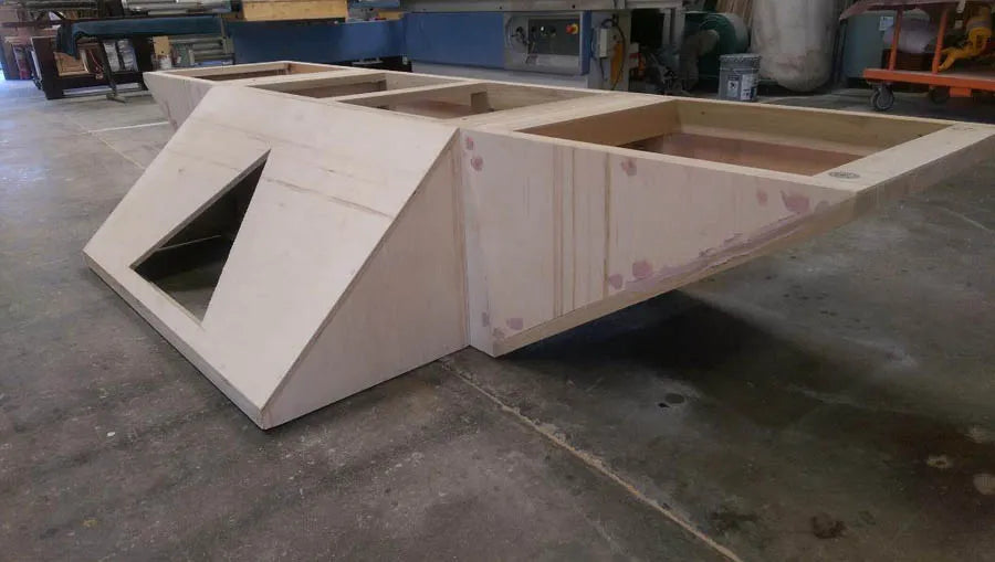 A custom pool table with an open white angular frame in the workshop