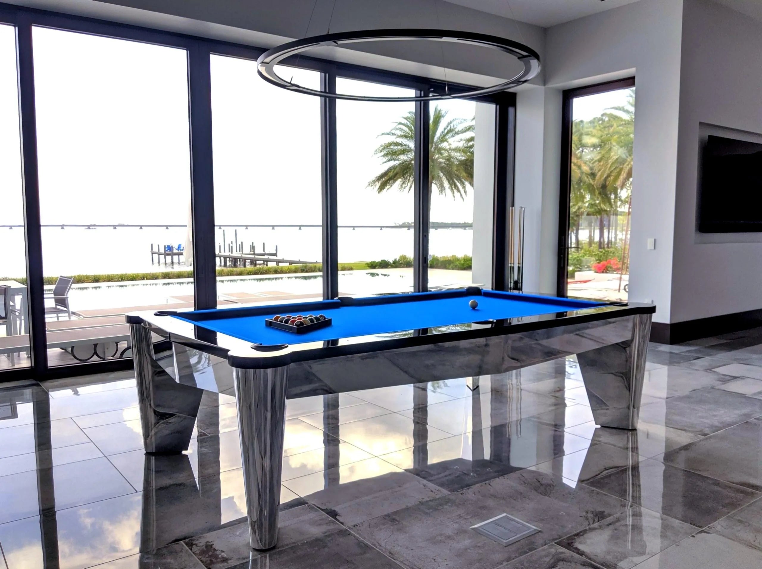 Modern pool table in a luxurious room with an ocean view